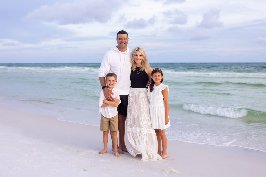 small family portrait of 4 wearing black white and off-white for a beach session on 30a at Watercolor.