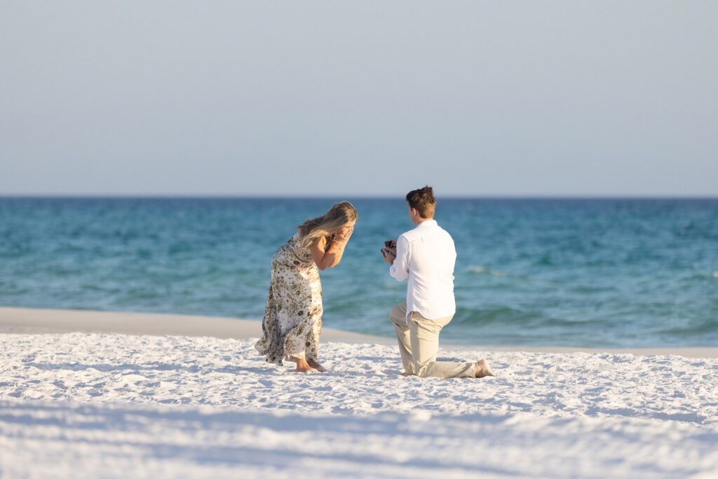 Man proposing to his girlfriend on beach on Hwy 30a