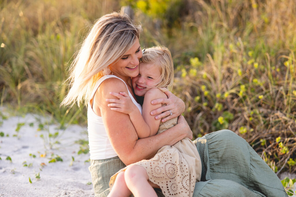 Mom and young daughter hugging photograph on the beaches of 30a