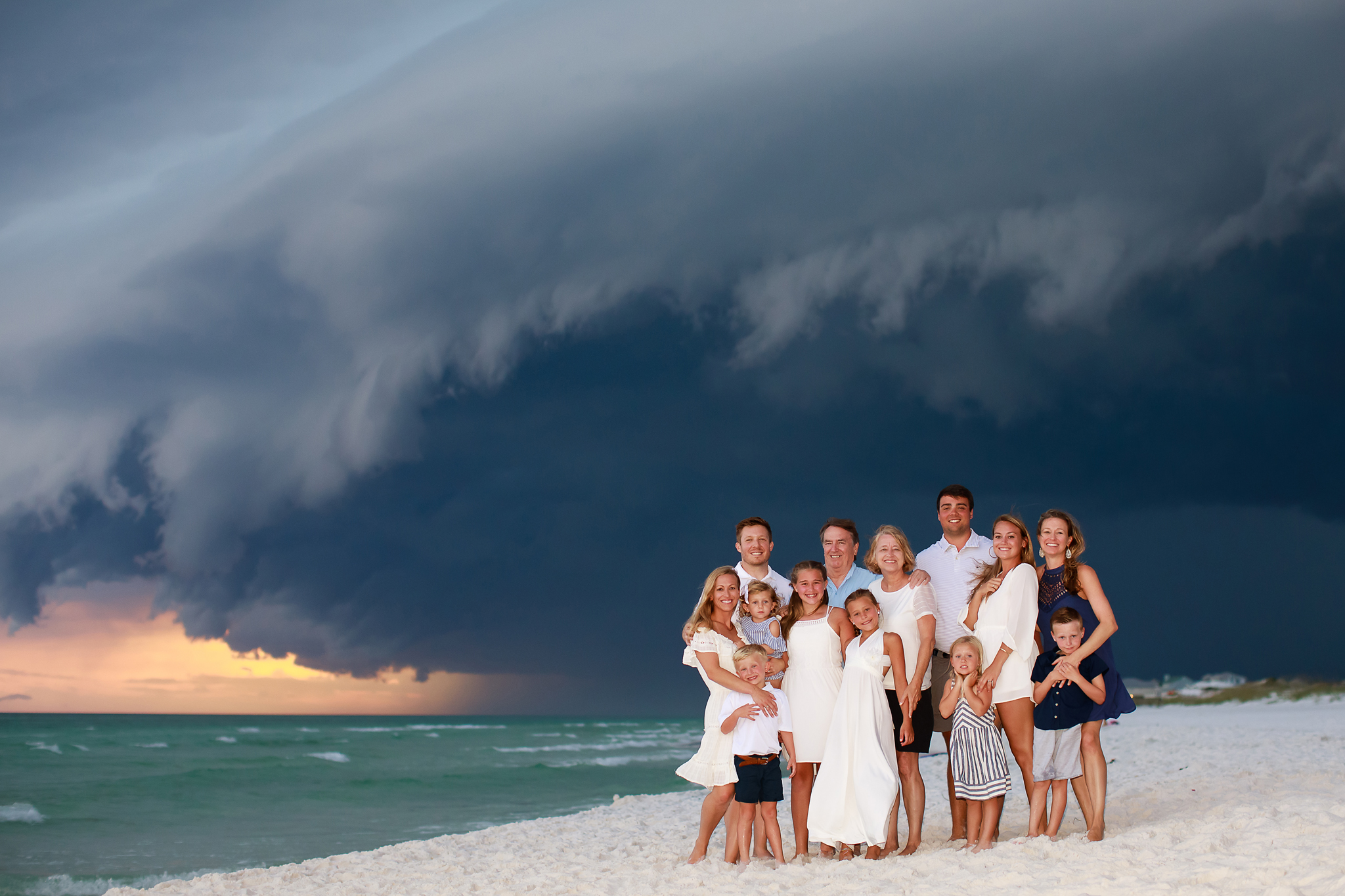 crazy clouds with a storm rolling in in the background of a family beach portrait in grayton Beach, FL on 30a.