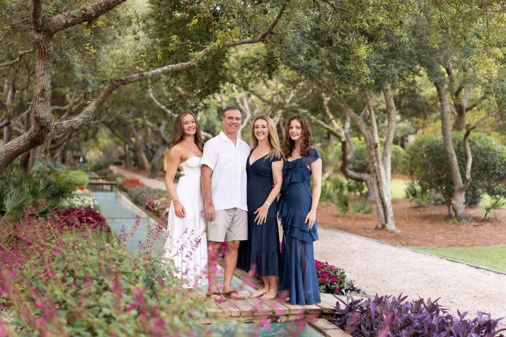 Family of four taking portraits in a park in Watercolor, Florida on 30a.