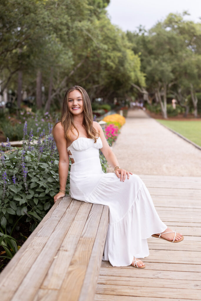 Young female posing for a portrait in park on 30a after graduating college.