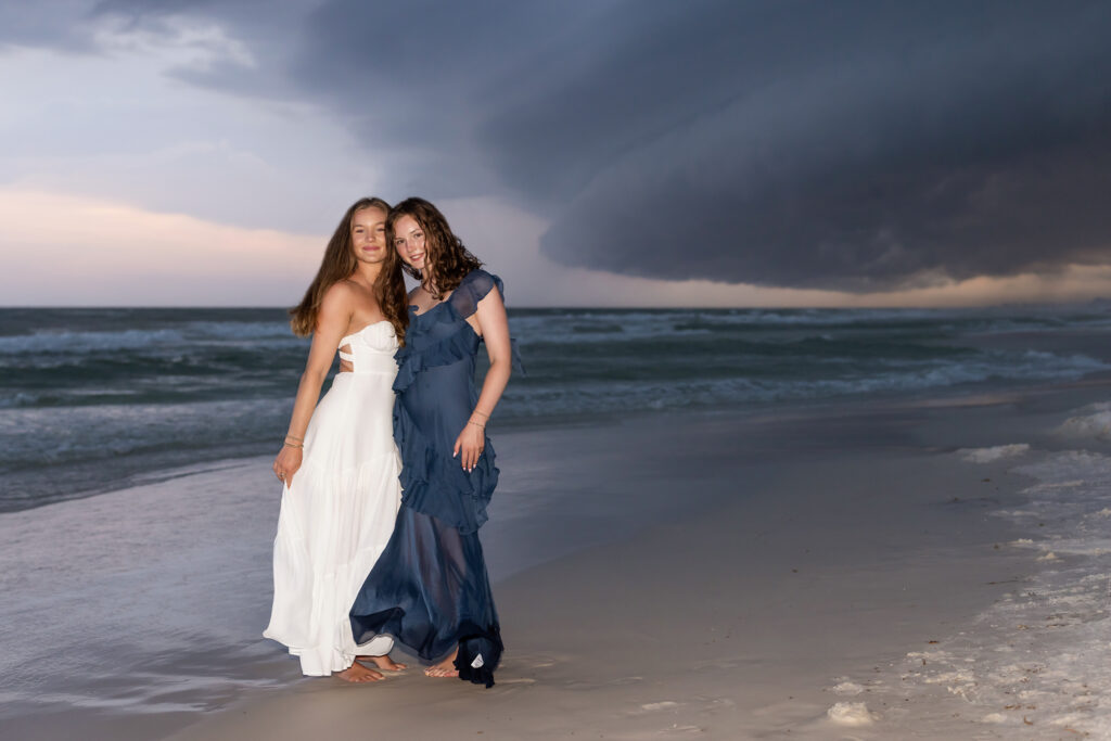 Crazy super cell storm cloud in background of a portrait of sisters posing on the beach in Watercolor on 30a.